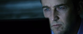 Movie still from “The Bourne Legacy” (2012), directed by Tony Gilroy – A man's face in the dark; Extreme Close Up shot, Over the shoulder angle