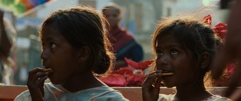 Movie still from “The Bourne Supremacy” (2004), directed by Paul Greengrass – Two young girls are eating some kind of food; Close Up shot, Low angle