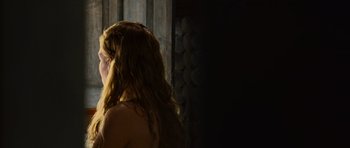 Movie still from “The Bourne Supremacy” (2004), directed by Paul Greengrass – A woman with long red hair standing next to a wall; Close Up shot, Over the shoulder angle