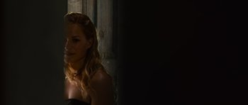 Movie still from “The Bourne Supremacy” (2004), directed by Paul Greengrass – A woman with long blonde hair standing next to a window; Close Up shot, Over the shoulder angle
