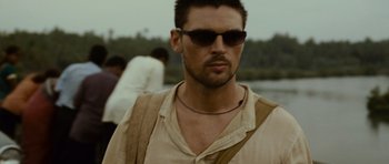 Movie still from “The Bourne Supremacy” (2004), directed by Paul Greengrass – A person wearing sunglasses; Close Up shot, Over the shoulder angle