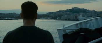 Movie still from “The Bourne Supremacy” (2004), directed by Paul Greengrass – A man standing on a boat looking out over the water; Extreme Wide shot, Over the shoulder angle