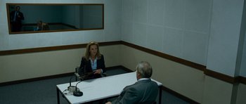Movie still from “The Bourne Supremacy” (2004), directed by Paul Greengrass – A woman sitting at a table in front of an older man; Wide shot, Over the shoulder angle