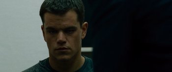 Movie still from “The Bourne Supremacy” (2004), directed by Paul Greengrass – A person wearing a black t - shirt; Close Up shot, Over the shoulder angle