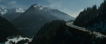 Movie still from “The Bourne Supremacy” (2004), directed by Paul Greengrass – A highway going through a valley with a mountain in the background; Extreme Wide shot, High angle