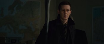 Movie still from “The Bourne Supremacy” (2004), directed by Paul Greengrass – A man wearing a black jacket and a tie; Close Up shot, Over the shoulder angle