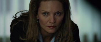 Movie still from “The Bourne Supremacy” (2004), directed by Paul Greengrass – A woman's face in a dark room; Close Up shot, Low angle