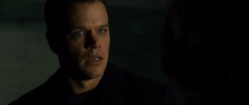 Movie still from “The Bourne Supremacy” (2004), directed by Paul Greengrass – A person in a dark room; Close Up shot, Over the shoulder angle