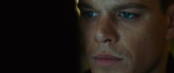 Movie still from “The Bourne Supremacy” (2004), directed by Paul Greengrass – A man's face in the dark; Extreme Close Up shot, Over the shoulder angle
