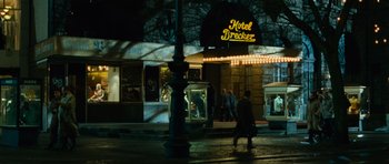 Movie still from “The Bourne Supremacy” (2004), directed by Paul Greengrass – People walking on the sidewalk in front of a building; Wide shot, Low angle