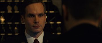 Movie still from “The Bourne Supremacy” (2004), directed by Paul Greengrass – A person wearing a suit and tie; Close Up shot, Over the shoulder angle