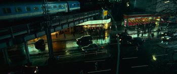 Movie still from “The Bourne Supremacy” (2004), directed by Paul Greengrass – A view of a train station at night from a window; Extreme Wide shot, High angle
