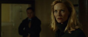 Movie still from “The Bourne Supremacy” (2004), directed by Paul Greengrass – A woman standing next to a man in a room; Close Up shot, Over the shoulder angle