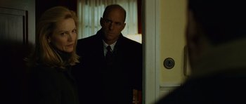 Movie still from “The Bourne Supremacy” (2004), directed by Paul Greengrass – A man and a woman standing next to each other in front of a door; Close Up shot, Over the shoulder angle