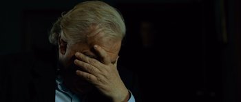 Movie still from “The Bourne Supremacy” (2004), directed by Paul Greengrass – An older man covering his face with his hands; Close Up shot, Over the shoulder angle