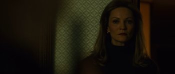 Movie still from “The Bourne Supremacy” (2004), directed by Paul Greengrass – A woman with long hair is standing in front of a wall; Close Up shot, Low angle