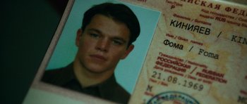 Movie still from “The Bourne Supremacy” (2004), directed by Paul Greengrass – A picture of a man's face on a foreign passport; Close Up shot, Overhead angle