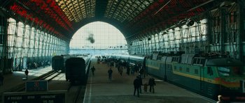 Movie still from “The Bourne Supremacy” (2004), directed by Paul Greengrass – A train station with people waiting for a train; Extreme Wide shot, High angle