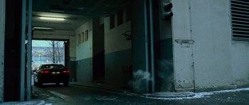 Movie still from “The Bourne Supremacy” (2004), directed by Paul Greengrass – Smoke coming out of a building near a traffic light; Wide shot, Low angle