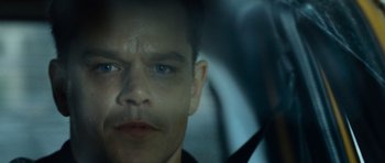 Movie still from “The Bourne Supremacy” (2004), directed by Paul Greengrass – A man's face in a car window; Close Up shot, Over the shoulder angle