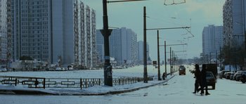 Movie still from “The Bourne Supremacy” (2004), directed by Paul Greengrass – A snowy street scene with buildings in the background; Extreme Wide shot, High angle