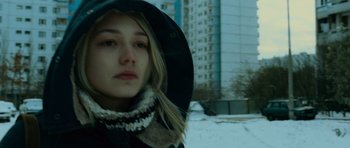 Movie still from “The Bourne Supremacy” (2004), directed by Paul Greengrass – A woman in a black hat and a black coat; Close Up shot, Low angle