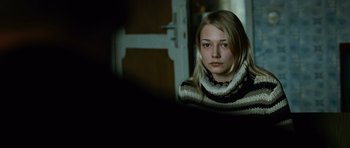 Movie still from “The Bourne Supremacy” (2004), directed by Paul Greengrass – A young blonde woman wearing a sweater looking at the camera; Close Up shot, Over the shoulder angle