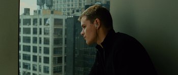 Movie still from “The Bourne Supremacy” (2004), directed by Paul Greengrass – A young man wearing a pair of ear buds; Close Up shot, Low angle