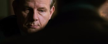 Movie still from “The Bourne Ultimatum” (2007), directed by Paul Greengrass – A man's face in the dark; Close Up shot, Over the shoulder angle