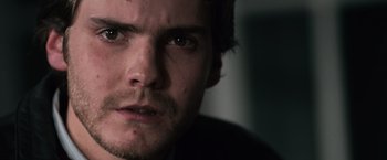 Movie still from “The Bourne Ultimatum” (2007), directed by Paul Greengrass – A man's face in a dark room; Extreme Close Up shot, Over the shoulder angle
