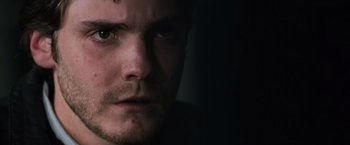 Movie still from “The Bourne Ultimatum” (2007), directed by Paul Greengrass – A man's face in the dark; Extreme Close Up shot, Over the shoulder angle