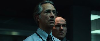 Movie still from “The Bourne Ultimatum” (2007), directed by Paul Greengrass – A man in a suit and tie standing next to another man in a tie; Close Up shot, Low angle