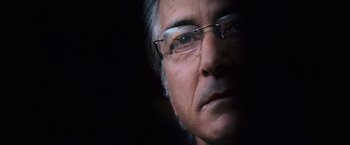 Movie still from “The Bourne Ultimatum” (2007), directed by Paul Greengrass – A person wearing glasses; Close Up shot, Low angle