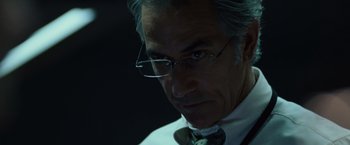 Movie still from “The Bourne Ultimatum” (2007), directed by Paul Greengrass – An older man wearing glasses and a bow tie; Close Up shot, Low angle