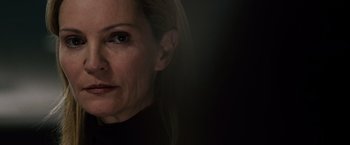 Movie still from “The Bourne Ultimatum” (2007), directed by Paul Greengrass – A woman's face in a dark room; Close Up shot, Over the shoulder angle