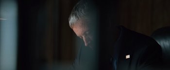 Movie still from “The Bourne Ultimatum” (2007), directed by Paul Greengrass – A person in a suit looking down; Extreme Close Up shot, High angle