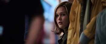 Movie still from “The Bourne Ultimatum” (2007), directed by Paul Greengrass – A young woman with long blonde hair looking to her left; Close Up shot, Over the shoulder angle