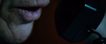 Movie still from “The Bourne Ultimatum” (2007), directed by Paul Greengrass – View of a person's mouth and ear; Extreme Close Up shot, High angle