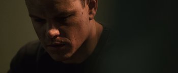 Movie still from “The Bourne Ultimatum” (2007), directed by Paul Greengrass – A person's face in a dark room; Close Up shot, Low angle
