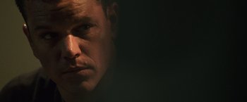 Movie still from “The Bourne Ultimatum” (2007), directed by Paul Greengrass – A man's face in the dark; Close Up shot, Low angle