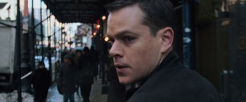 Movie still from “The Bourne Ultimatum” (2007), directed by Paul Greengrass – A person wearing a black jacket; Close Up shot, Over the shoulder angle