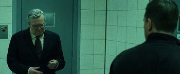 Movie still from “The Bourne Ultimatum” (2007), directed by Paul Greengrass – A man standing in front of a bathroom mirror; Medium shot, Over the shoulder angle