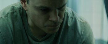 Movie still from “The Bourne Ultimatum” (2007), directed by Paul Greengrass – A man's face in a green shirt; Close Up shot, Overhead angle