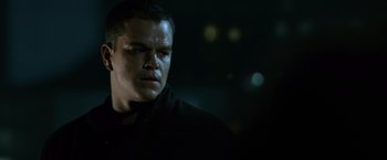 Movie still from “The Bourne Ultimatum” (2007), directed by Paul Greengrass – A person wearing a black shirt; Close Up shot, Low angle