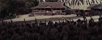 Movie still from “The Bridge on the River Kwai” (1957), directed by David Lean – A group of people standing in front of a building; Extreme Wide shot, High angle