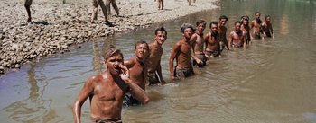 Movie still from “The Bridge on the River Kwai” (1957), directed by David Lean – A number of men in a body of water near one another; Wide shot, High angle