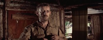 Movie still from “The Bridge on the River Kwai” (1957), directed by David Lean – A person holding a cell phone; Close Up shot, Low angle