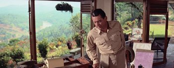 Movie still from “The Bridge on the River Kwai” (1957), directed by David Lean – A man standing in front of an open window; Medium shot, Low angle