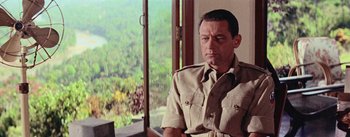 Movie still from “The Bridge on the River Kwai” (1957), directed by David Lean – A person sitting in front of a window; Close Up shot, Over the shoulder angle