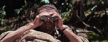 Movie still from “The Bridge on the River Kwai” (1957), directed by David Lean – A man looking through a pair of binoculars; Close Up shot, Low angle